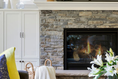 Elegant dark wood floor and brown floor living room photo in Minneapolis with gray walls and a stone fireplace