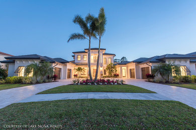 Large modern white two-story exterior home idea in Orlando