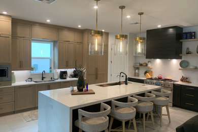 Eat-in kitchen - mid-sized modern l-shaped porcelain tile and gray floor eat-in kitchen idea in Miami with an undermount sink, shaker cabinets, brown cabinets, quartz countertops, white backsplash, quartz backsplash, paneled appliances, an island and white countertops