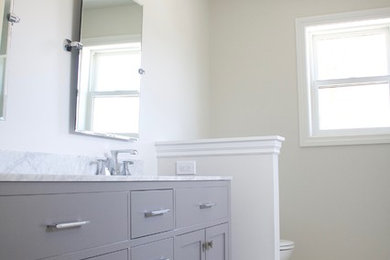 Example of a classic master terrazzo floor and white floor bathroom design in Detroit with gray cabinets and marble countertops