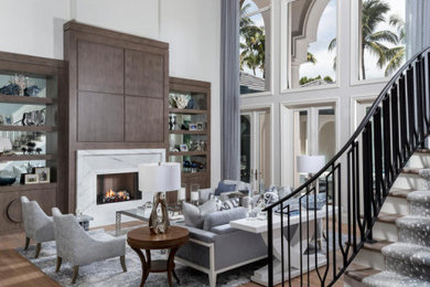 Living room - huge transitional formal and open concept medium tone wood floor, brown floor and coffered ceiling living room idea in Miami with gray walls, a standard fireplace, a stone fireplace and no tv