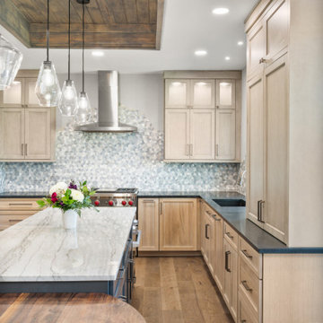 Modern Two-Tone Kitchen with Marble Island and Geometric Backsplash