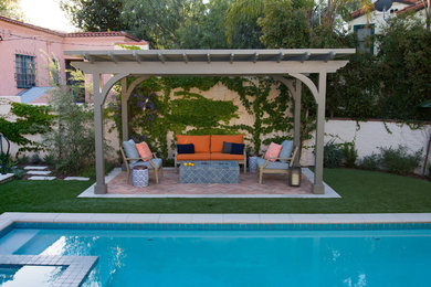 Inspiration for a small mediterranean backyard partial sun xeriscape for spring in Los Angeles with brick pavers.