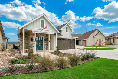Example of a mid-sized blue one-story mixed siding house exterior design in Austin with a shingle roof
