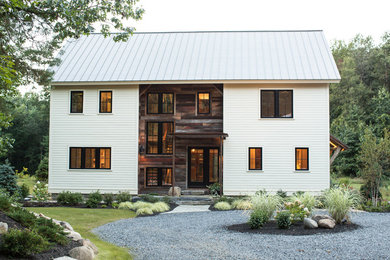 Inspiration for a two-storey white exterior in Boston with wood siding.