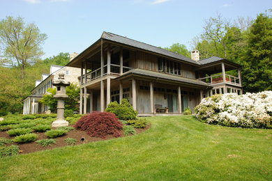 Example of a large classic beige three-story wood exterior home design in Baltimore with a metal roof