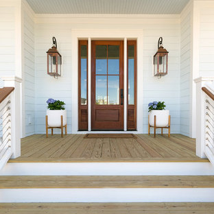 Immagine di una grande porta d'ingresso country con pareti blu, parquet chiaro, una porta singola, una porta in vetro e pavimento beige