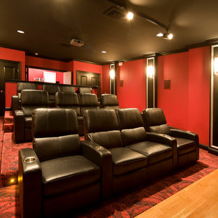 Inspiration for a transitional carpeted home theater remodel in Burlington with red walls and a projector screen