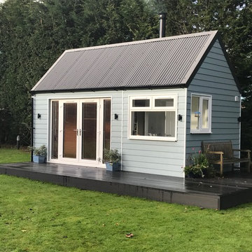 Garden room with mezzanine bed, shower, kitchen and fire.