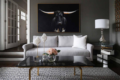 Example of a transitional enclosed medium tone wood floor and brown floor living room design in Chicago with gray walls and a standard fireplace