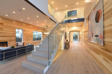 Example of a mid-sized minimalist formal and open concept light wood floor and beige floor living room design in Los Angeles with beige walls, a standard fireplace, a wood fireplace surround and no tv