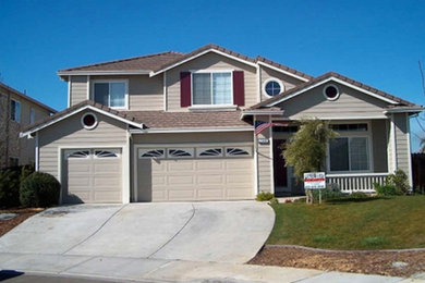 Example of a mid-sized beige two-story wood exterior home design in San Francisco with a shingle roof
