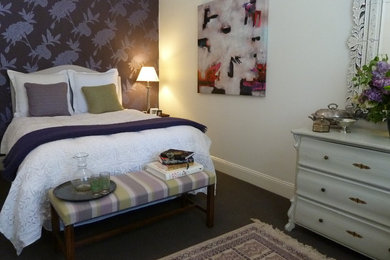 Inspiration for a mid-sized transitional master bedroom in Melbourne with white walls and carpet.