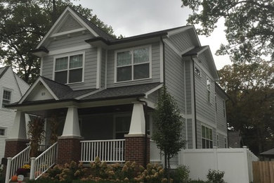 Inspiration for a large country gray two-story concrete fiberboard gable roof remodel in Detroit