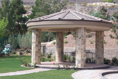 Example of a brick patio design in Las Vegas with a gazebo