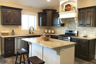Inspiration for a large transitional u-shaped porcelain tile open concept kitchen remodel in Other with an undermount sink, raised-panel cabinets, dark wood cabinets, granite countertops, beige backsplash, stone tile backsplash, stainless steel appliances and an island