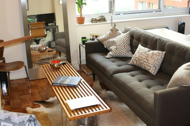 Small 1950s open concept medium tone wood floor living room photo in New York with beige walls and a wall-mounted tv