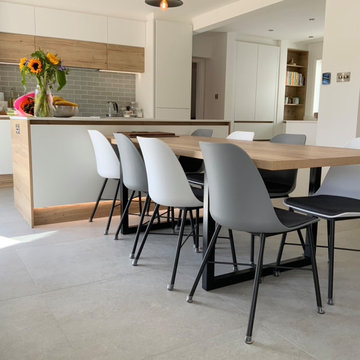 Scandi oak and white open plan family kitchen with custom dining table