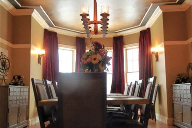 Example of a large mountain style medium tone wood floor and brown floor enclosed dining room design in Boston with beige walls and no fireplace