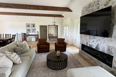 Mountain style living room photo in Toronto with a stone fireplace
