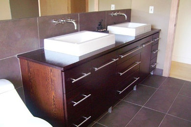 This is an example of a mid-sized traditional master bathroom in Other with a trough sink, flat-panel cabinets, wood benchtops, a one-piece toilet, brown tile, beige walls and terra-cotta floors.