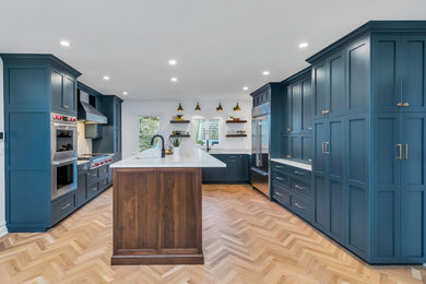 Transitional kitchen photo in Newark with shaker cabinets and an island