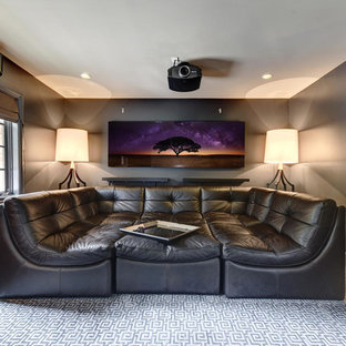 Home theater - mid-sized transitional enclosed carpeted and multicolored floor home theater idea in Austin with gray walls and a projector screen