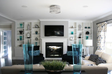 Mid-sized 1960s open concept dark wood floor and brown floor family room photo in Other with gray walls, a standard fireplace, a wood fireplace surround and a wall-mounted tv