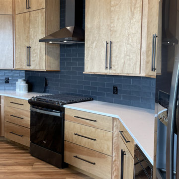 Angled Kitchen Design with Slab Style Cabinets in Pecan Stain
