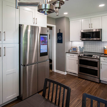 White Kitchen with White Tile Backsplash and Quartz Countertop