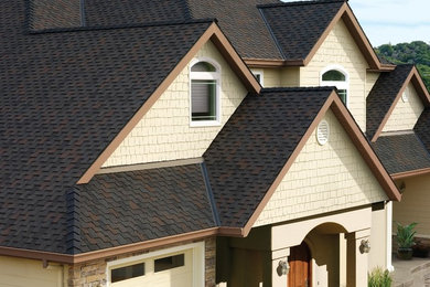 This is an example of a transitional exterior in Seattle with a shingle roof.