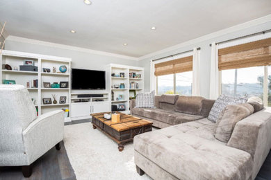 Example of a minimalist enclosed dark wood floor and brown floor living room design in San Diego with gray walls, no fireplace and a wall-mounted tv