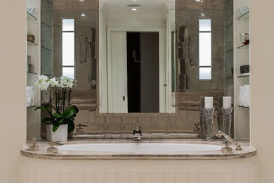 Example of a large transitional beige tile and stone tile limestone floor alcove shower design in Boston with an undermount sink, furniture-like cabinets, white cabinets, an undermount tub and beige walls