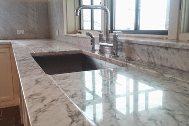Inspiration for a mid-sized transitional porcelain tile open concept kitchen remodel in Austin with an undermount sink, shaker cabinets, white cabinets, marble countertops, gray backsplash, marble backsplash and stainless steel appliances