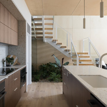 Kitchen with full-height terrazzo backsplash - Fold House Berkeley Hills