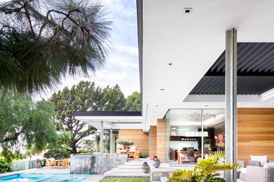 Example of a large 1950s multicolored one-story glass house exterior design in Los Angeles