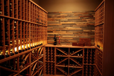 Example of a mid-sized classic medium tone wood floor wine cellar design in Vancouver
