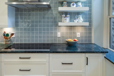 Mid-sized transitional galley brown floor kitchen photo in Other with an undermount sink, shaker cabinets, white cabinets, granite countertops, gray backsplash, ceramic backsplash, stainless steel appliances and a peninsula