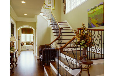 Staircase - large traditional wooden u-shaped staircase idea in Charlotte with painted risers