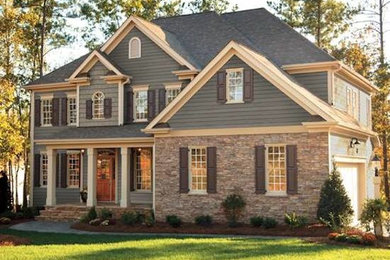 Example of a mid-sized transitional green two-story mixed siding exterior home design in Other