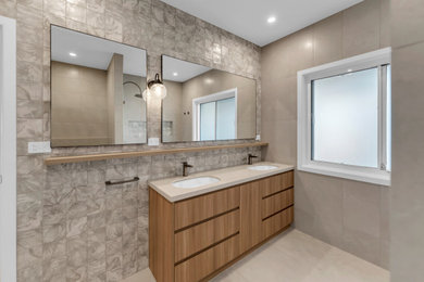 Example of a mid-sized minimalist master multicolored tile ceramic tile and double-sink bathroom design in Melbourne with medium tone wood cabinets, gray walls, a drop-in sink, white countertops and a built-in vanity