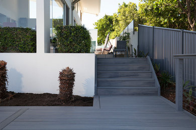 This is an example of a beach style backyard patio in Sunshine Coast with decking and no cover.