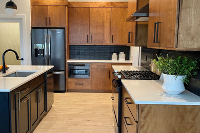 Large 1950s l-shaped light wood floor and brown floor open concept kitchen photo in Other with an undermount sink, flat-panel cabinets, medium tone wood cabinets, quartz countertops, black backsplash, subway tile backsplash, black appliances, an island and white countertops