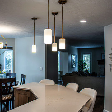 Two Tone Kitchen with Floating Shelves and Island Seating and Updated Fireplace