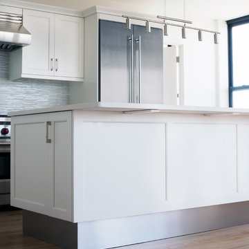Island with extended height stainless steel backsplash