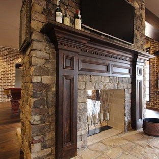 Photo of an expansive classic walk-out basement in Atlanta with brown walls, a two-sided fireplace, a stone fireplace surround and dark hardwood flooring.