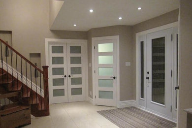 Inspiration for a large transitional entryway remodel in Ottawa with beige walls and a white front door