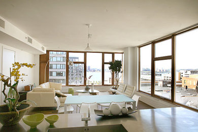 Example of a large trendy formal and loft-style medium tone wood floor living room design in New York with white walls and no fireplace