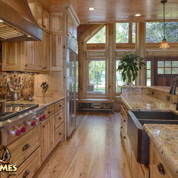 Rustic kitchen in a Golden Eagle Log and Timber Home model Lakehouse 4166AL