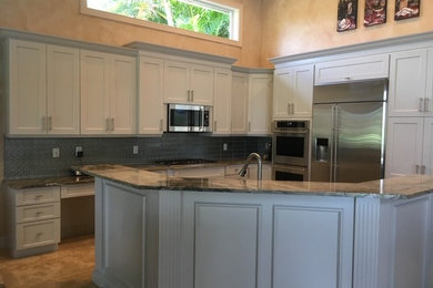 Open concept kitchen - contemporary l-shaped marble floor and beige floor open concept kitchen idea in Other with an undermount sink, shaker cabinets, gray cabinets, granite countertops, metallic backsplash, metal backsplash, stainless steel appliances, an island and gray countertops